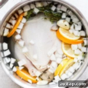 A whole chicken fully submerged in the brine, chilling in a covered pot in the refrigerator.