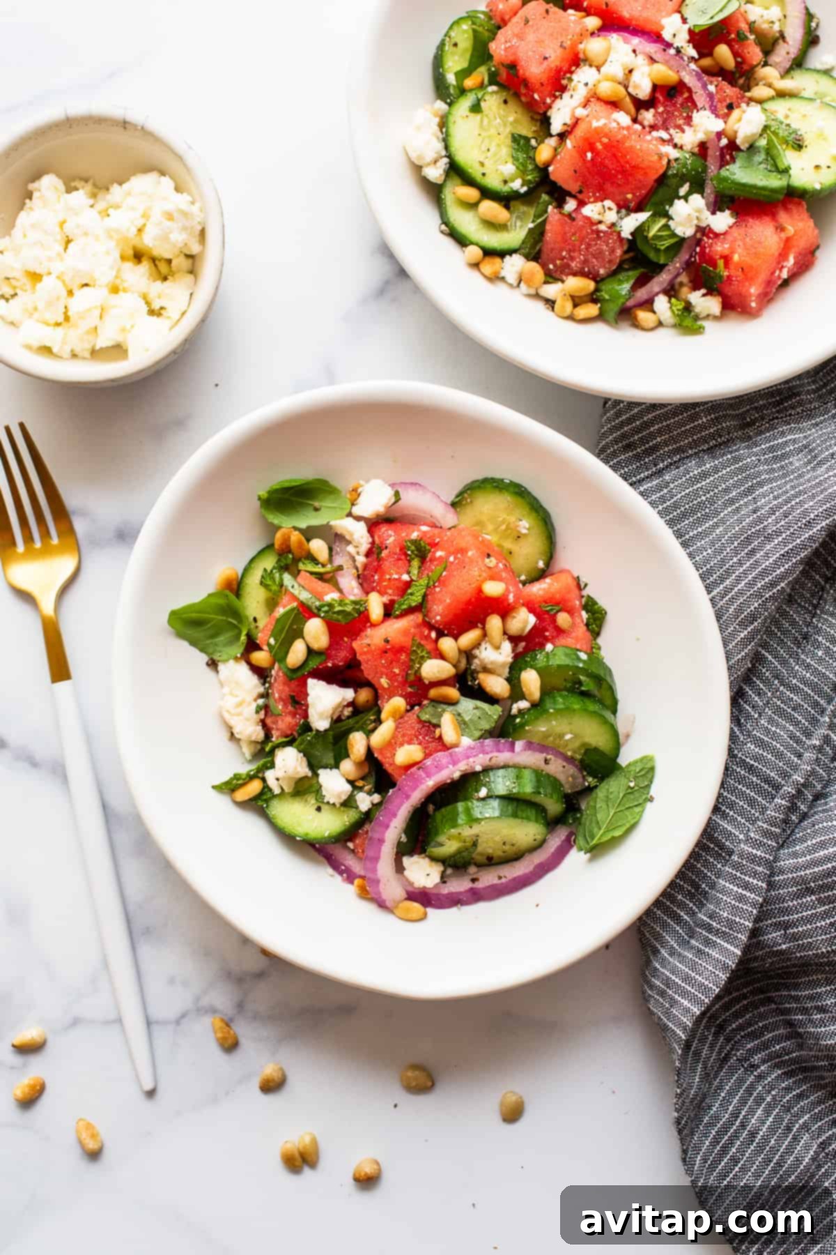 A beautifully presented bowl of watermelon salad, showcasing its fresh ingredients and vibrant colors.
