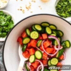 Watermelon and cucumber salad in a bowl, awaiting dressing.