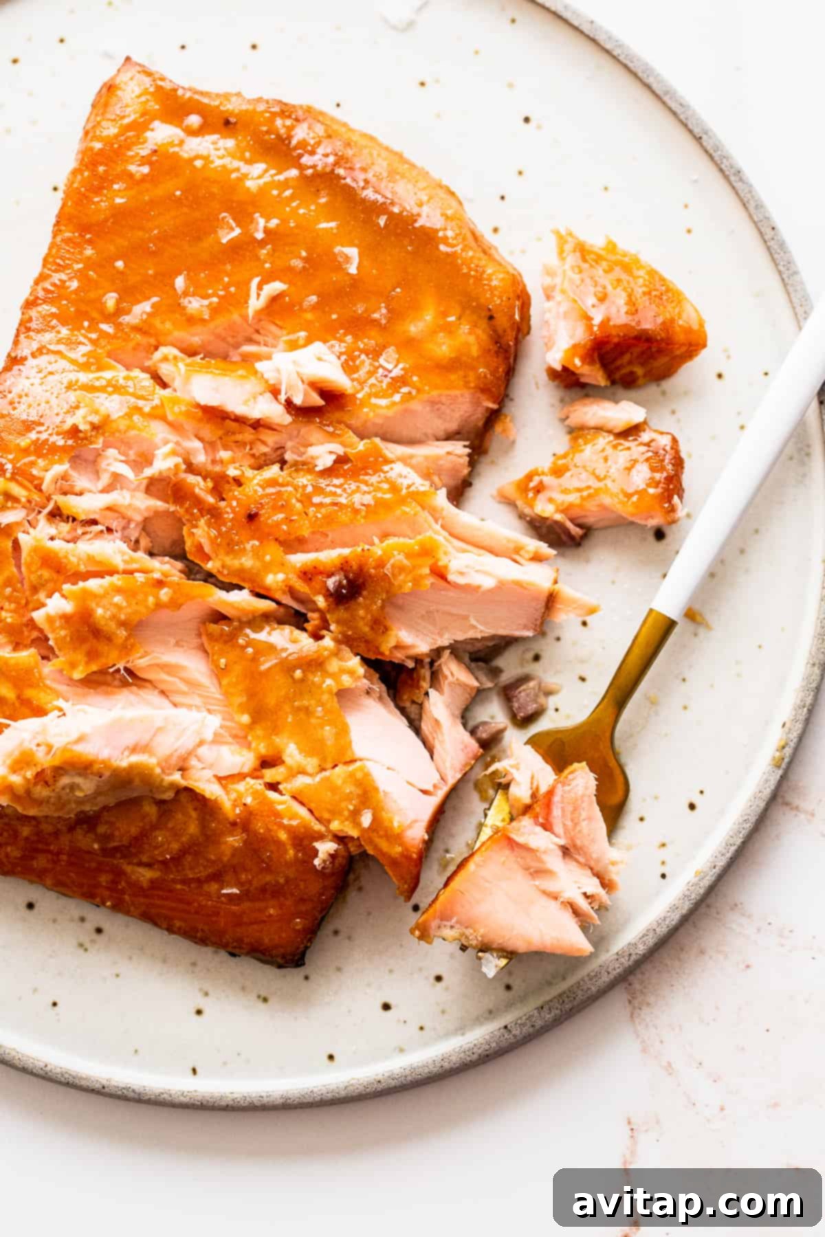 Beautifully flaked smoked salmon on a plate, ready to be incorporated into various dishes.
