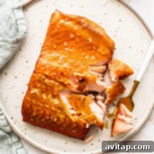 Exquisitely smoked maple mustard salmon glistening on a plate, ready to be served.