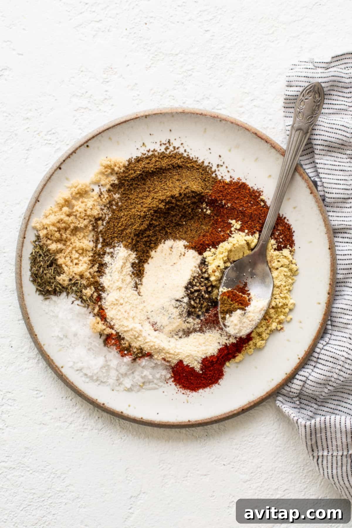 Various spices mixed together on a plate, showcasing the vibrant Old Bay blend.