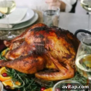 Tender Smoked Turkey Legs 4 A perfectly golden-brown smoked turkey on a platter, ready for carving.