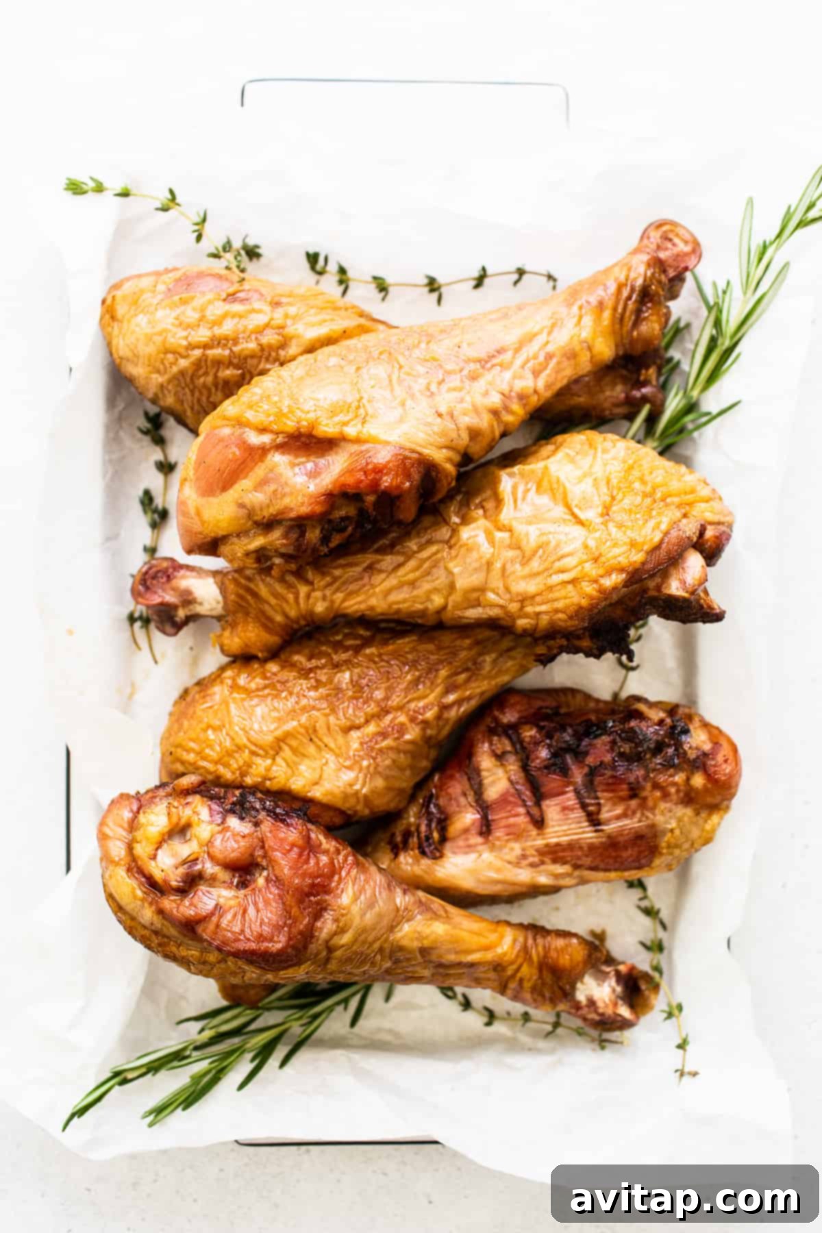 Tender Smoked Turkey Legs 5 Smoked turkey legs arranged beautifully on a serving platter, ready for a feast.