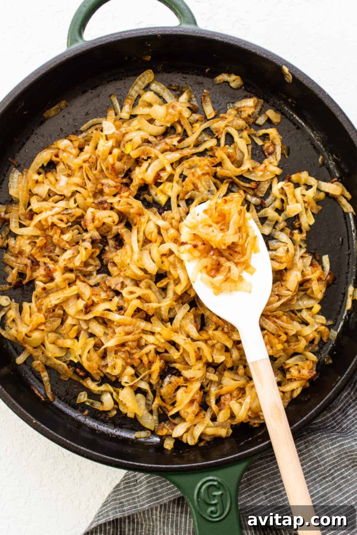 Effortless Golden Caramelized Onions 2 Rich, golden-brown caramelized onions shimmering in a large skillet, beautifully cooked and ready to elevate any meal.