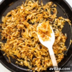 Finished browned caramelized onions in a skillet, displaying their rich, caramelized texture.