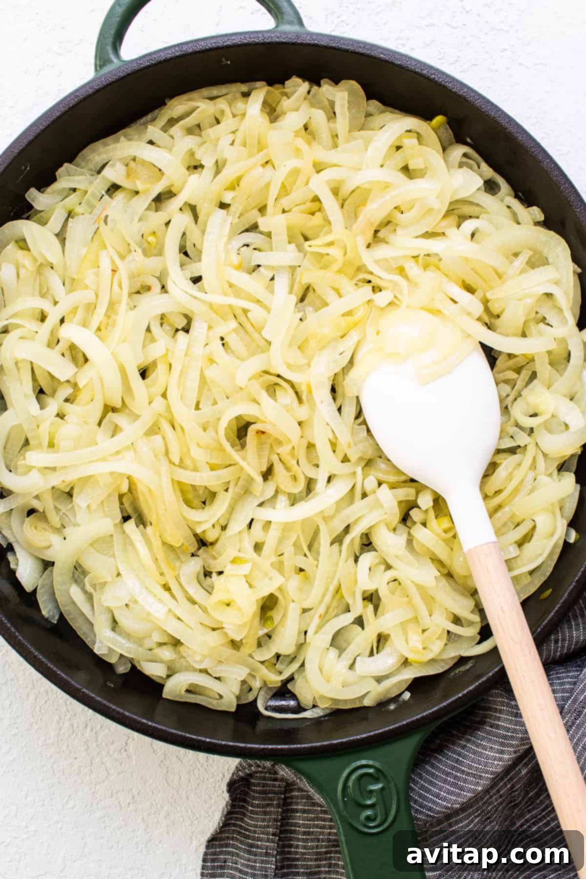 Effortless Golden Caramelized Onions 5 A large batch of glistening, rich brown caramelized onions in a skillet, perfect for a week of meal enhancement.