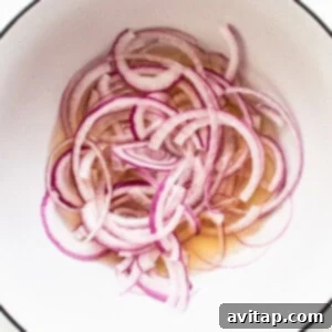 Quick pickling onions in a bowl.