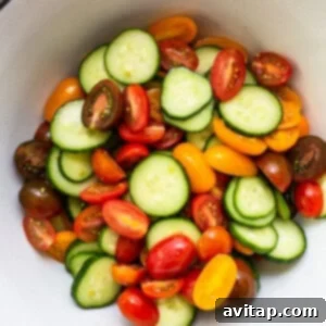 Salted tomatoes and cucumbers in a bowl.