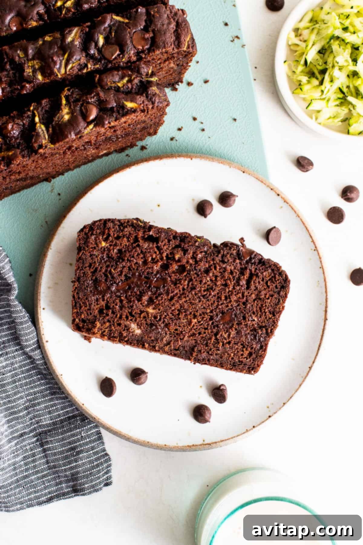 A delectable slice of chocolate zucchini bread displayed on a plate, showcasing its moist texture and rich chocolate chunks.