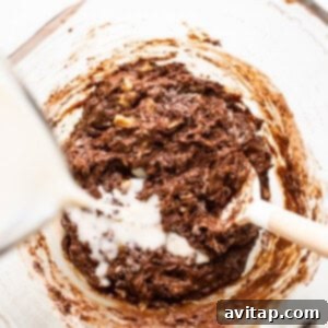 Chocolate cookie batter being mixed in a bowl.
