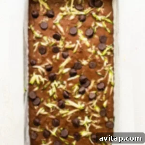 A baking pan filled with chocolate chips and green chile.