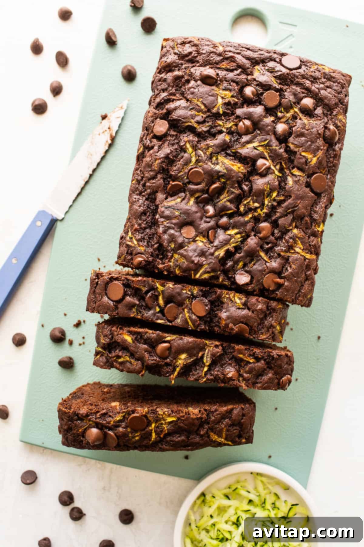 A loaf of chocolate zucchini bread freshly sliced into perfect portions.