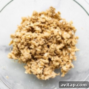 Streusel topping ingredients being mixed in a bowl, showcasing the crumbly texture being formed.