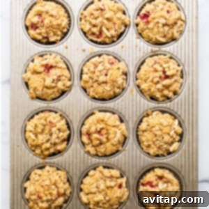 Muffins in a tin, topped with streusel, perfectly prepared and ready for baking.