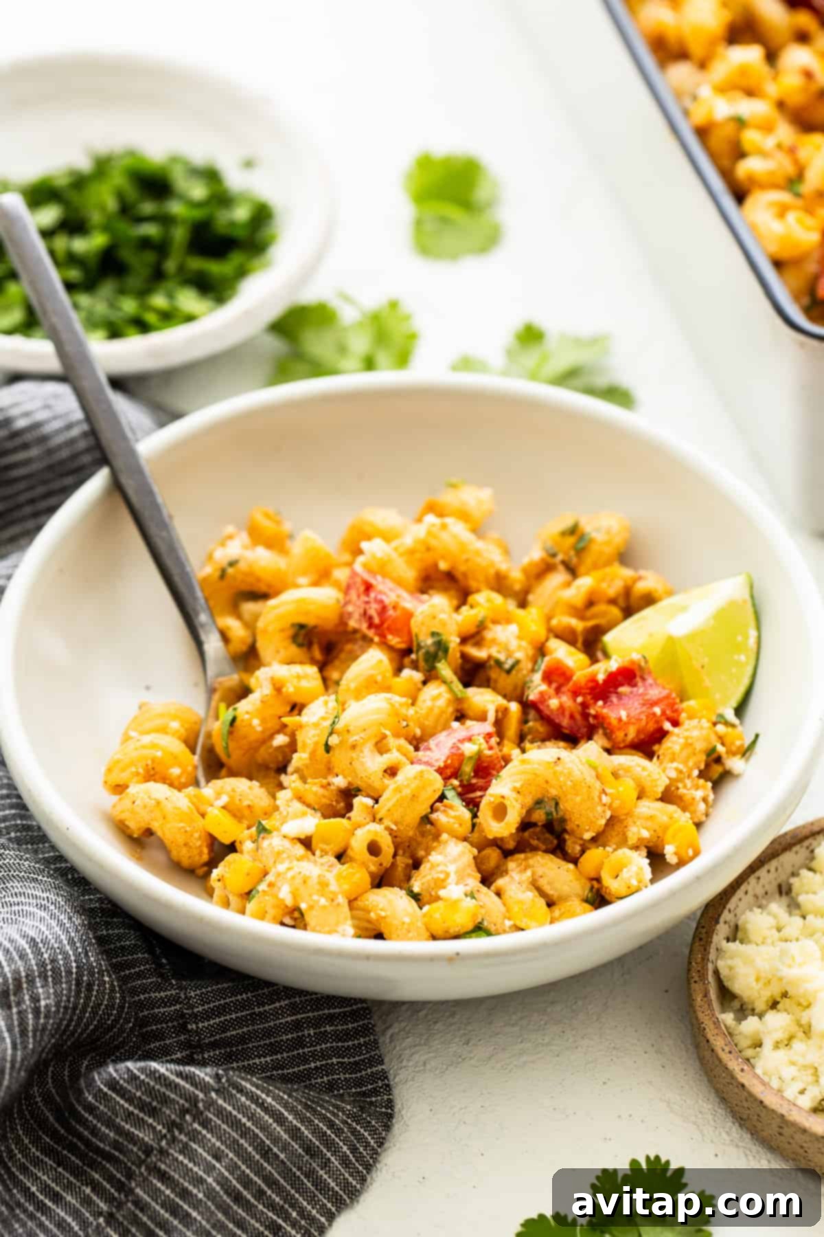 Fiesta Corn Pasta Salad 6 Close-up shot of Mexican Street Corn Pasta Salad in a large serving bowl, showcasing its creamy texture and fresh ingredients.