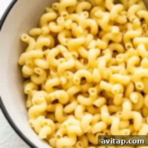 Fiesta Corn Pasta Salad 8 Cooked macaroni in a white bowl on a light surface.