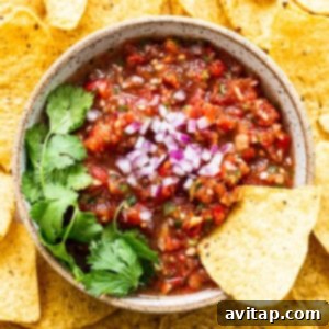 A vibrant bowl of fresh homemade salsa, perfectly blended and ready to serve.