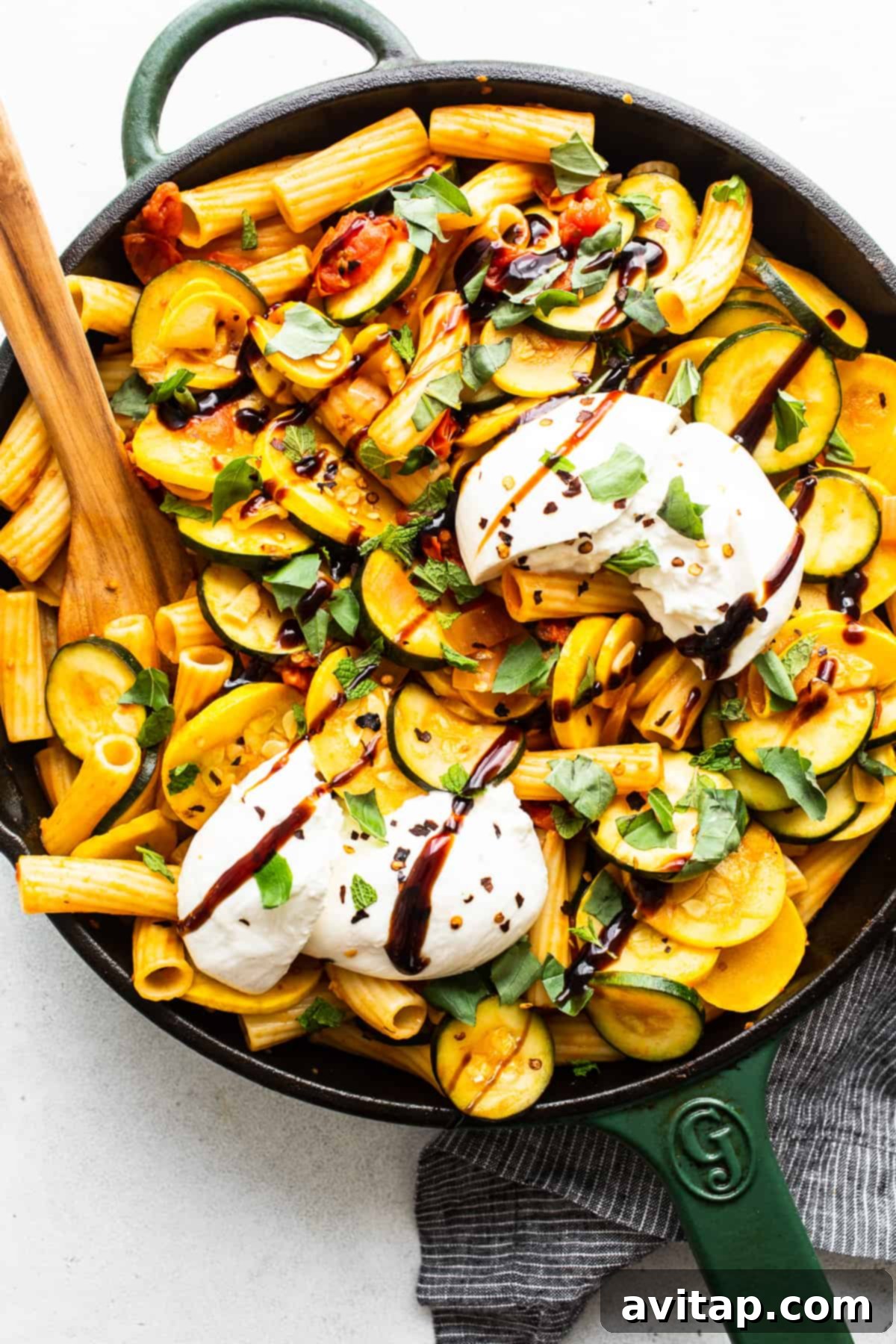 Summer squash pasta in a skillet, showcasing vibrant colors and fresh ingredients.