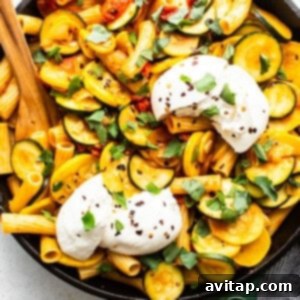 Creamy burrata cheese placed atop the warm summer squash pasta.
