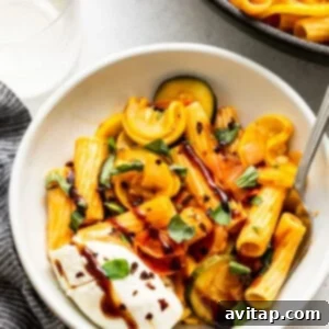 Delicious summer squash pasta with burrata cheese and balsamic glaze, ready to eat.