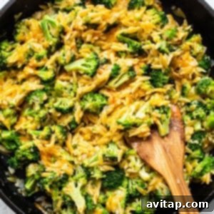 Broccoli cheese casserole, rich and golden, bubbling in a rustic cast iron skillet, ready to be served.