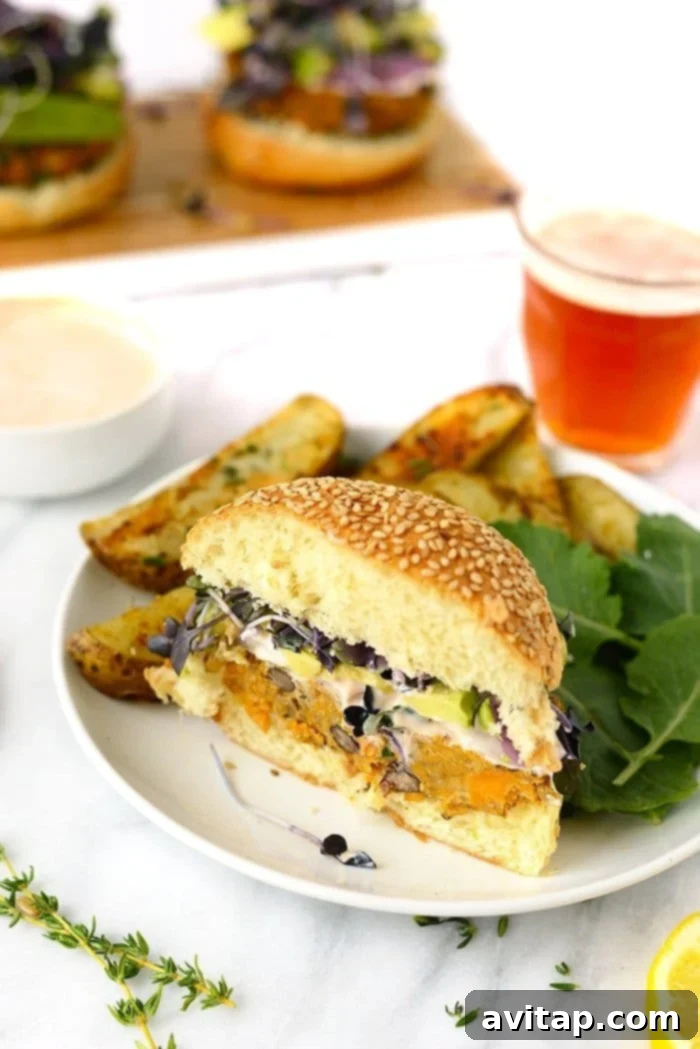 A perfectly cooked Quinoa Sweet Potato Black Bean Burger, cut in half to show its hearty interior.