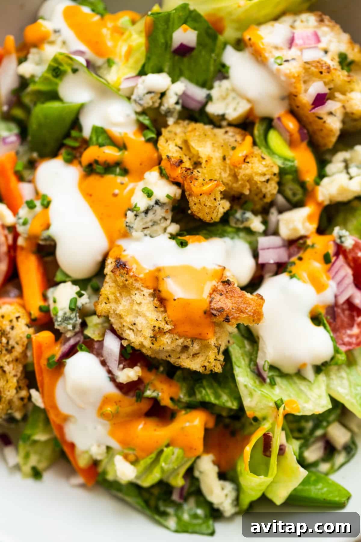 Close-Up of Homemade Crouton in Garden Salad A close-up shot of a perfectly golden, crunchy homemade crouton nestled among the vibrant greens and colorful vegetables of the ultimate garden salad, highlighting its appealing texture and integration.