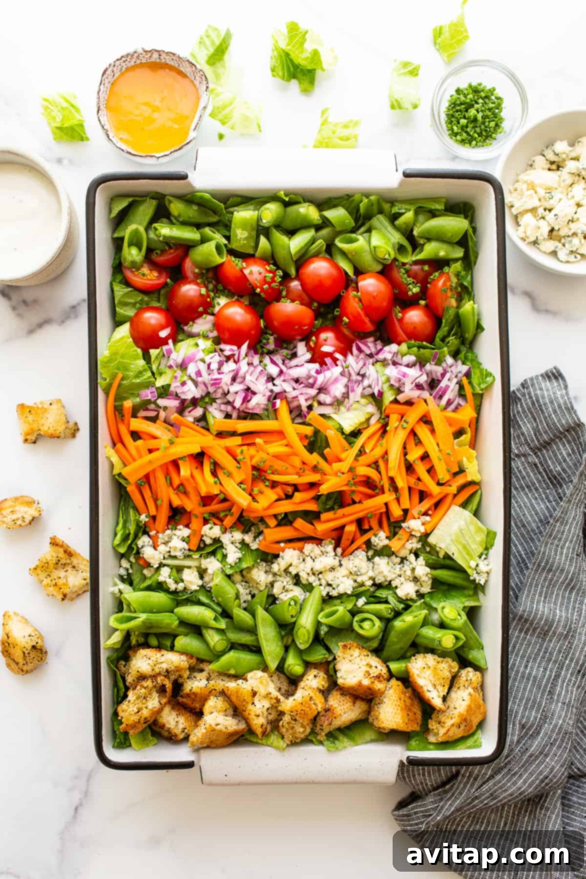 Eat the rainbow with this ultimate garden salad and homemade croutons tossed in French and blue cheese dressing. Enjoy as a side or a main dish! A vibrant garden salad in a stylish serving bowl, beautifully topped with golden, crispy homemade croutons, ready to be tossed and served.