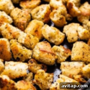 Vibrant Garden Medley 3 Golden, crispy homemade croutons simmering in a cast iron pan, glistening with olive oil and seasoned to perfection.