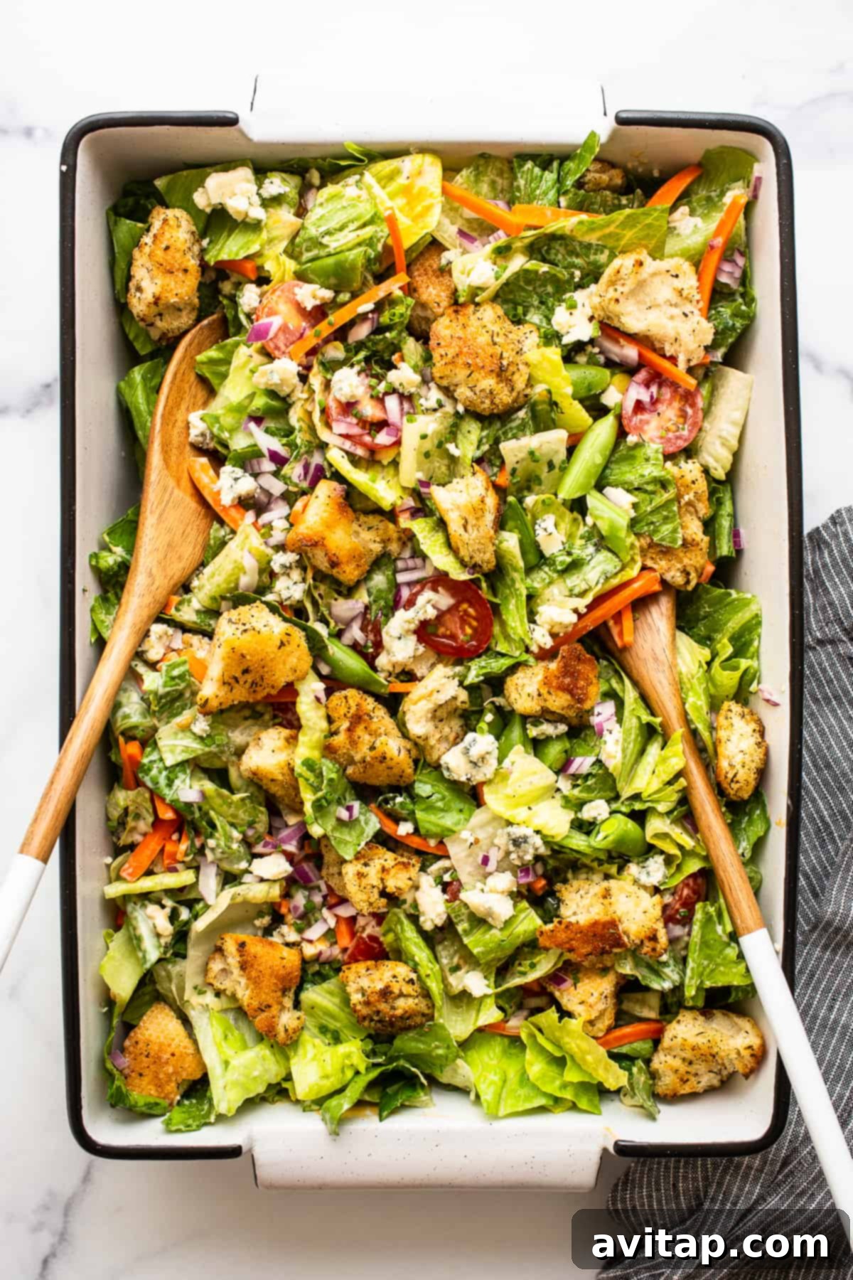 Tossed Ultimate Garden Salad Ready to Serve A vibrant and freshly tossed Ultimate Garden Salad, showcasing a medley of colorful vegetables, homemade croutons, and dressings beautifully intertwined, ready for serving.