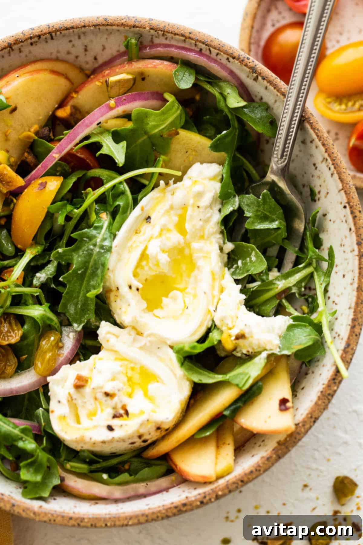 A beautifully presented Apple Burrata Salad, ready to be enjoyed as a main course or a sophisticated side dish.