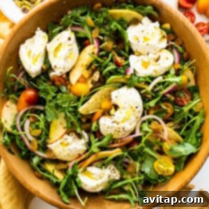 Apple burrata salad in a bowl, showcasing fresh ingredients.