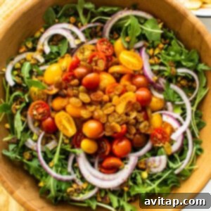 Various salad ingredients layered in a bowl.