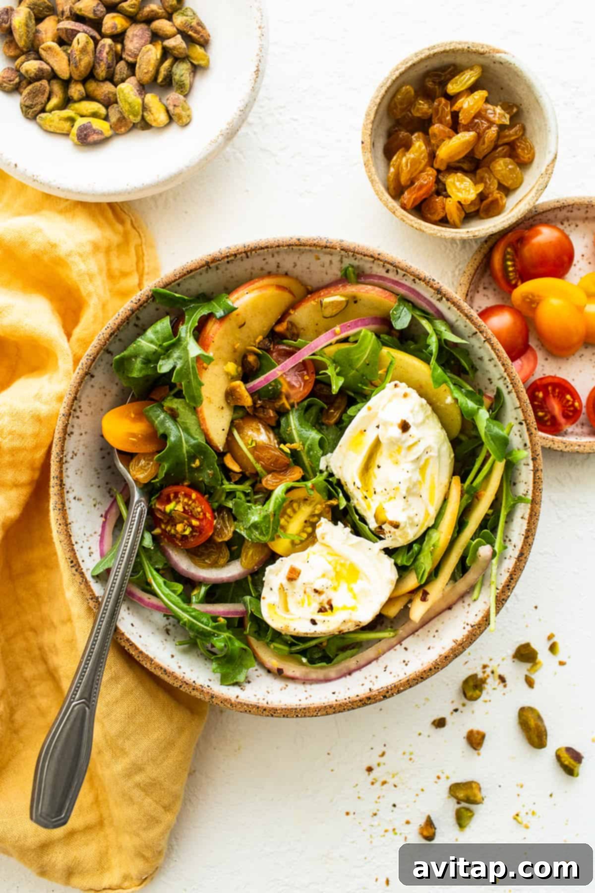 A close-up of the delicious Apple Burrata Salad in a rustic serving bowl, highlighting its fresh ingredients.