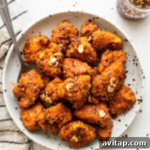 A bowl filled with finished Air Fryer Hot Honey Chicken, garnished and ready to be served.
