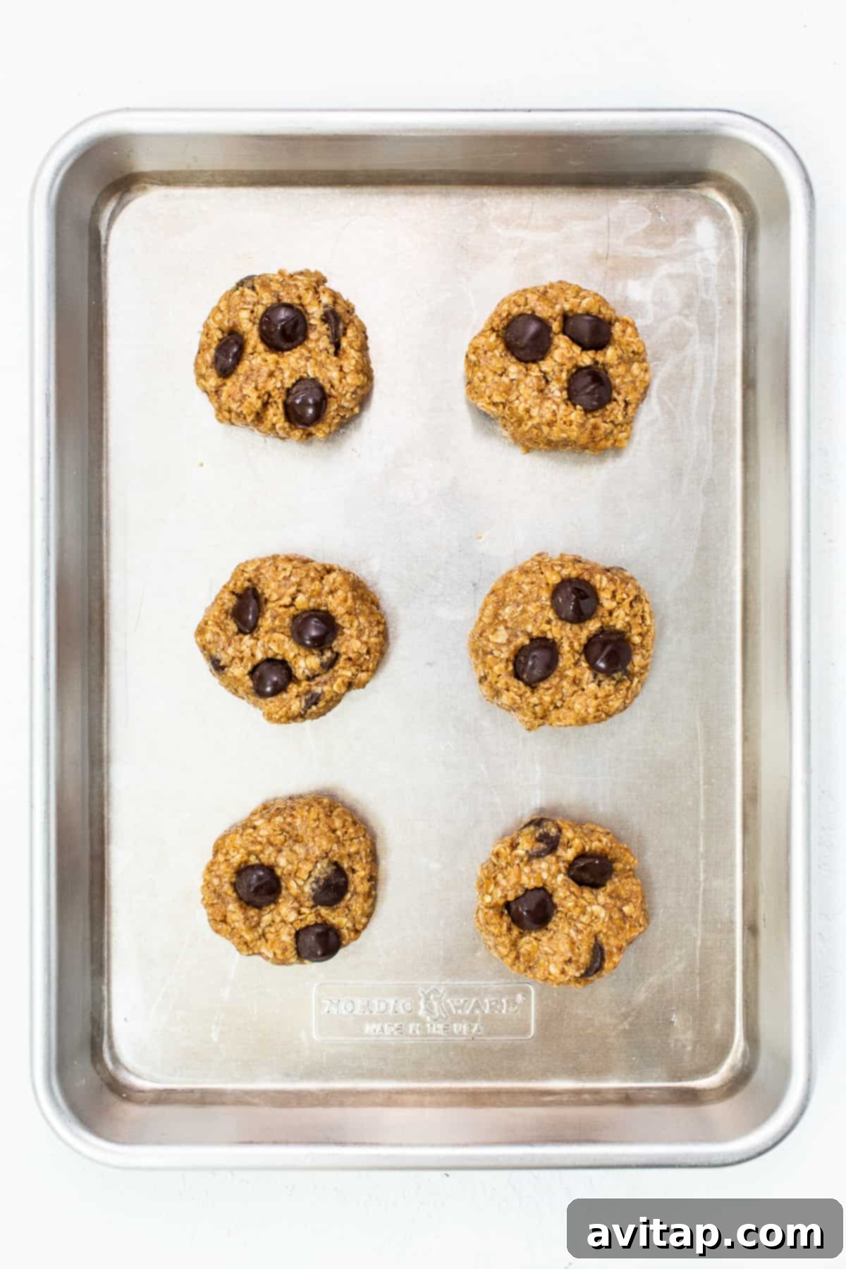Golden brown lactation cookies fresh out of the oven, still on the baking sheet.
