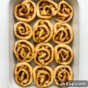Apple cinnamon rolls arranged in a baking dish.