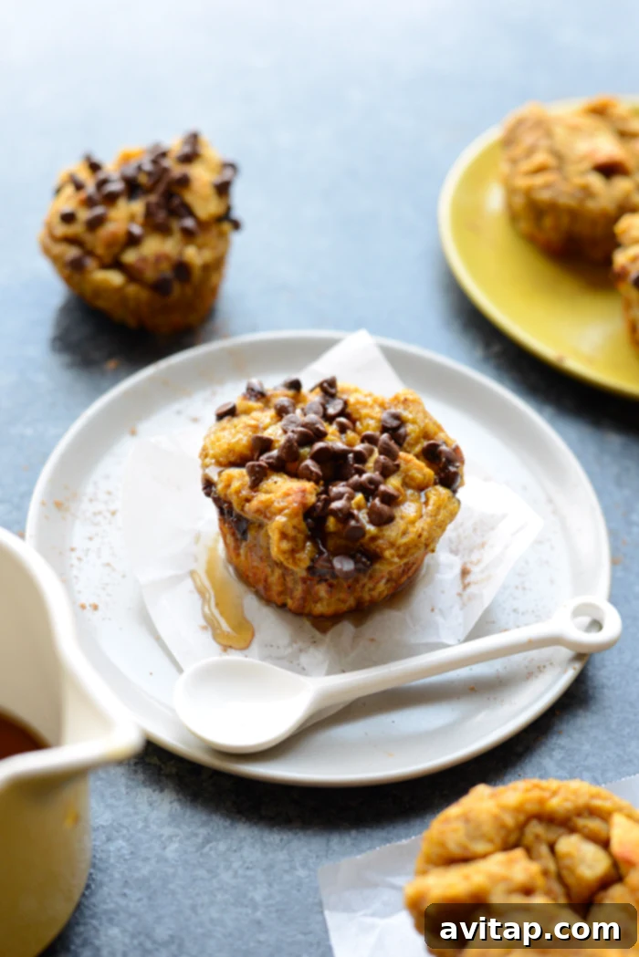 Charming pumpkin chocolate chip french toast cups, served individually on a plate, perfect for a fall breakfast.