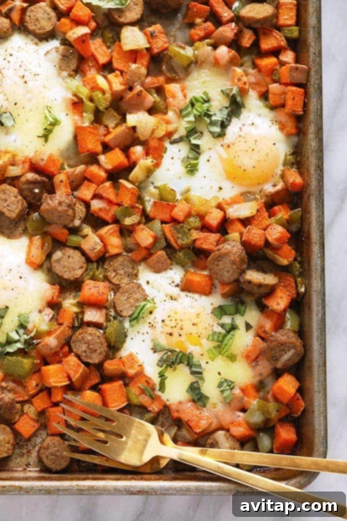 A generously portioned sheet pan sweet potato hash, garnished with fresh herbs, ready to be served for a hearty breakfast.