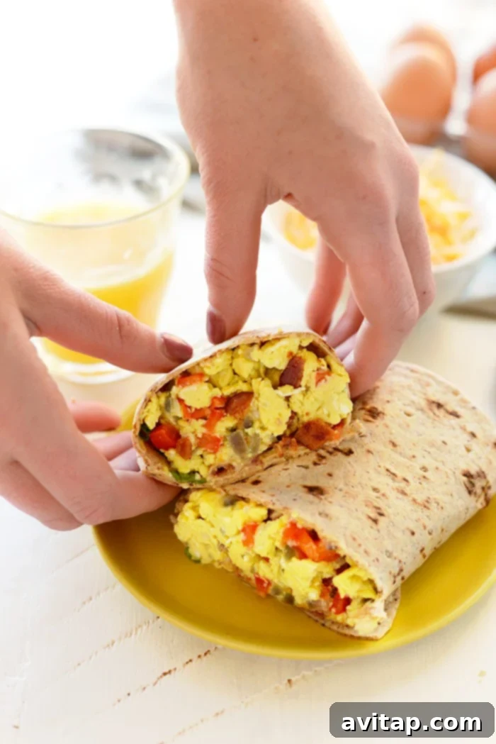 Hearty protein-packed breakfast burritos, expertly rolled and arranged on a plate, ready for meal prepping.