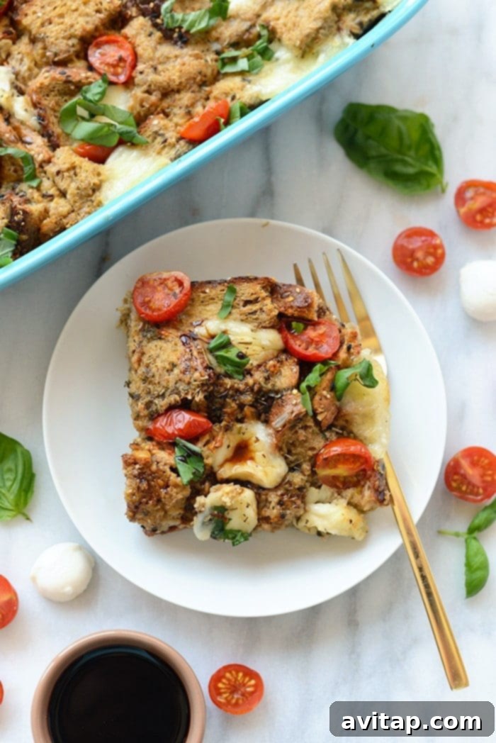 A perfectly portioned slice of Caprese Egg Bake being gently lifted from the casserole dish, revealing its layered textures and rich flavors, garnished with fresh basil leaves and a glistening drizzle of dark balsamic glaze.
