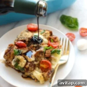 A person is pouring balsamic glaze on a Caprese Egg Bake, with fresh ingredients in the background, ready to be served.