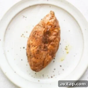 A cooked sweet potato on a plate.