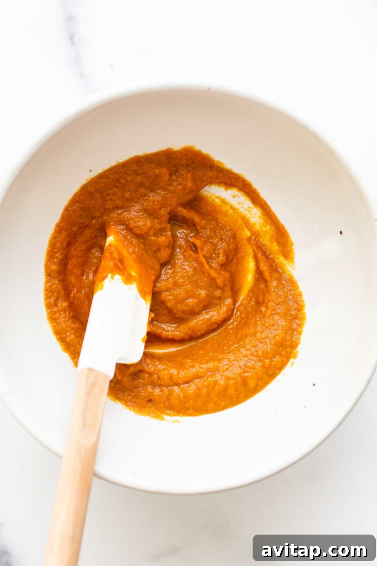 Creamy Pumpkin Mixture for French Toast Rich pumpkin filling mixture in a white bowl, ready for the French toast.