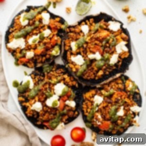 A plate of perfectly stuffed portobello mushrooms, ready to be served.