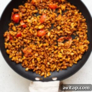 Walnut filling mixture cooking in a skillet with spices and onions.