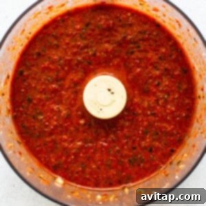 Roasted red pepper sauce blending in a food processor.