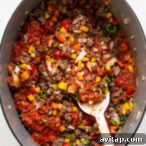 All Texas chili ingredients simmering in a pot.