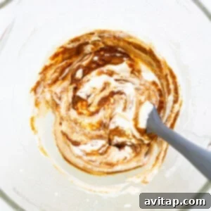 A bowl of whipped cream with a spoon in it.